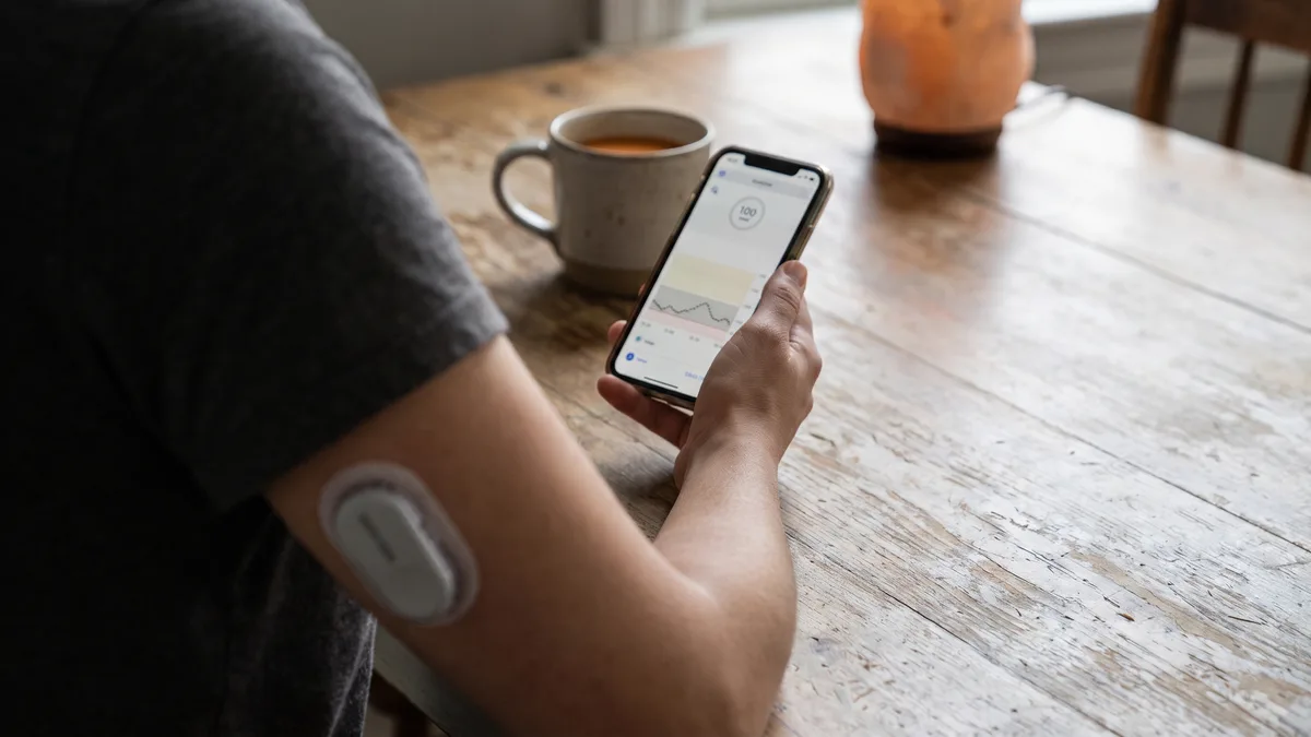 Dexcom CGM device and smartphone app displaying glucose levels